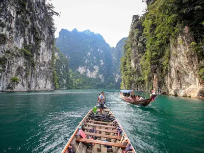 Adventure into the lush jungle of Khao Sok, surrounded by towering mountains and crystal-clear rivers