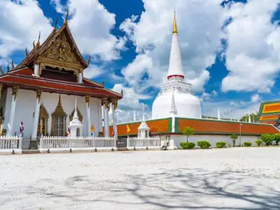 Cultural immersion en route to Nakhon Si Thammarat, traveling through lush tropical landscapes to the ancient Wat Phra Mahathat temple